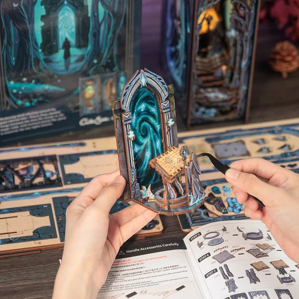 Hænder holder samlet CUTEBEE DIY Book Nook Kit – The Gate of Wonderland-port med spiralportal og lille skrin